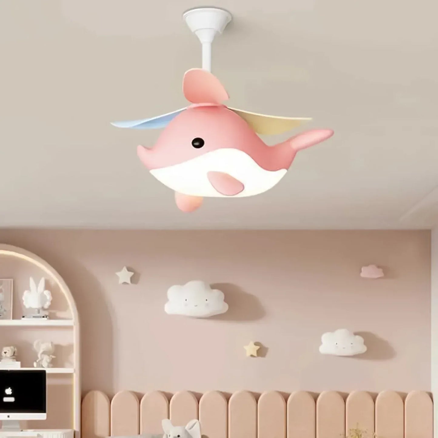 Pink cartoon Whimsy Whale Kids Ceiling Fan in a child's room with decorative wall items.