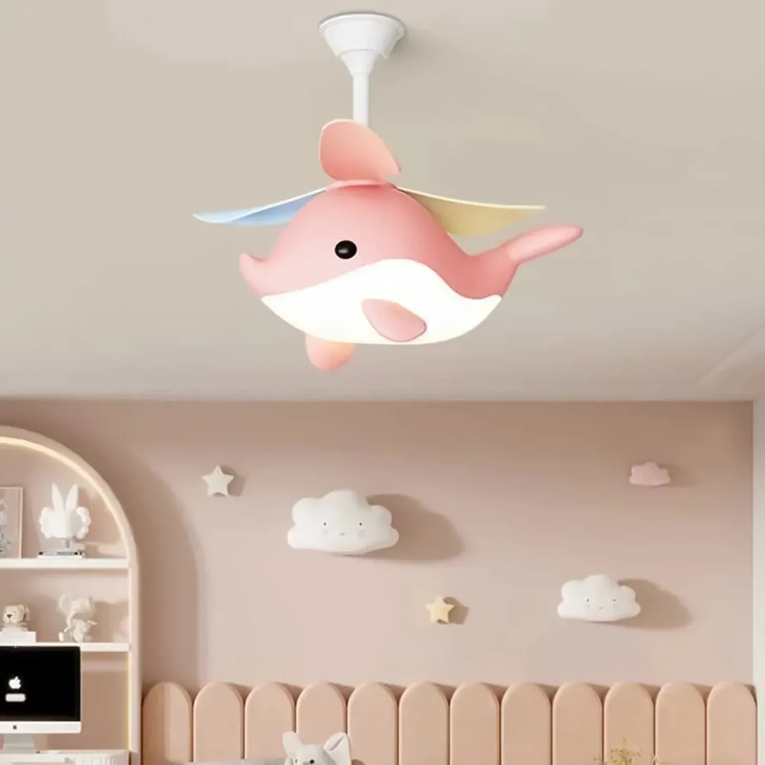 Pink cartoon Whimsy Whale Kids Ceiling Fan in a child's room with decorative wall items.