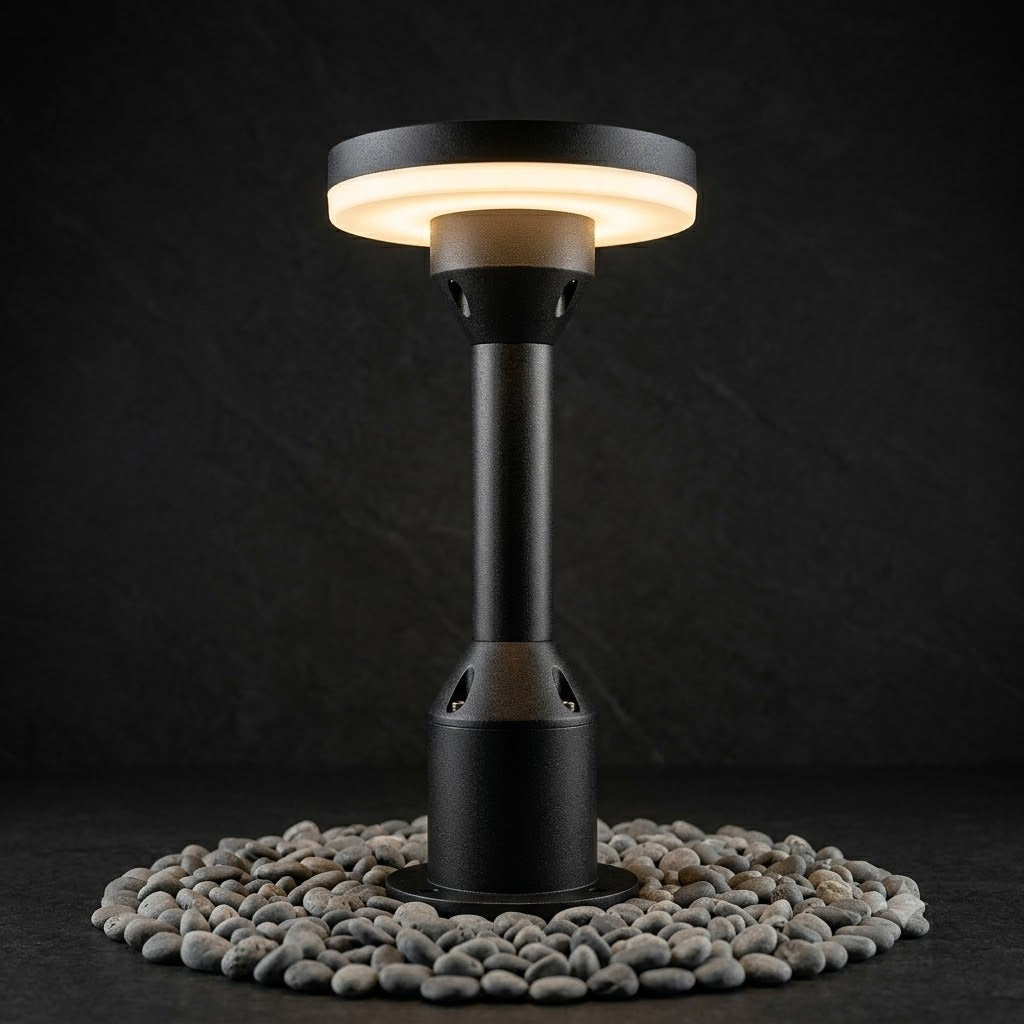 Black outdoor patio heater on a bed of small stones with a dark background